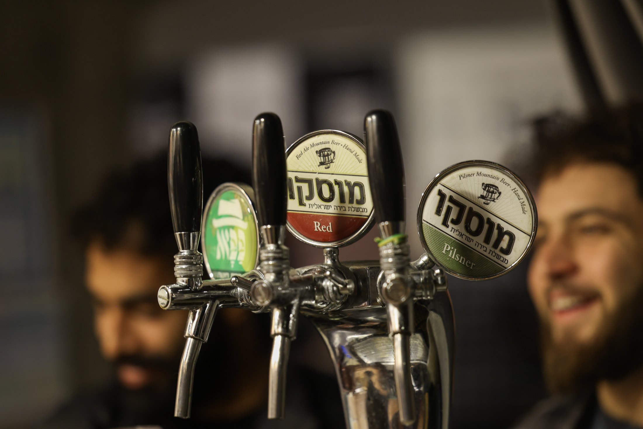 Beer taps with branded labels behind a counter.