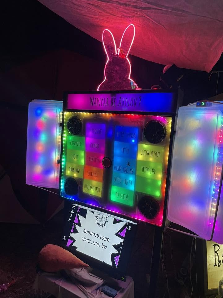 An illuminated rabbit figure sits above a colourful box.