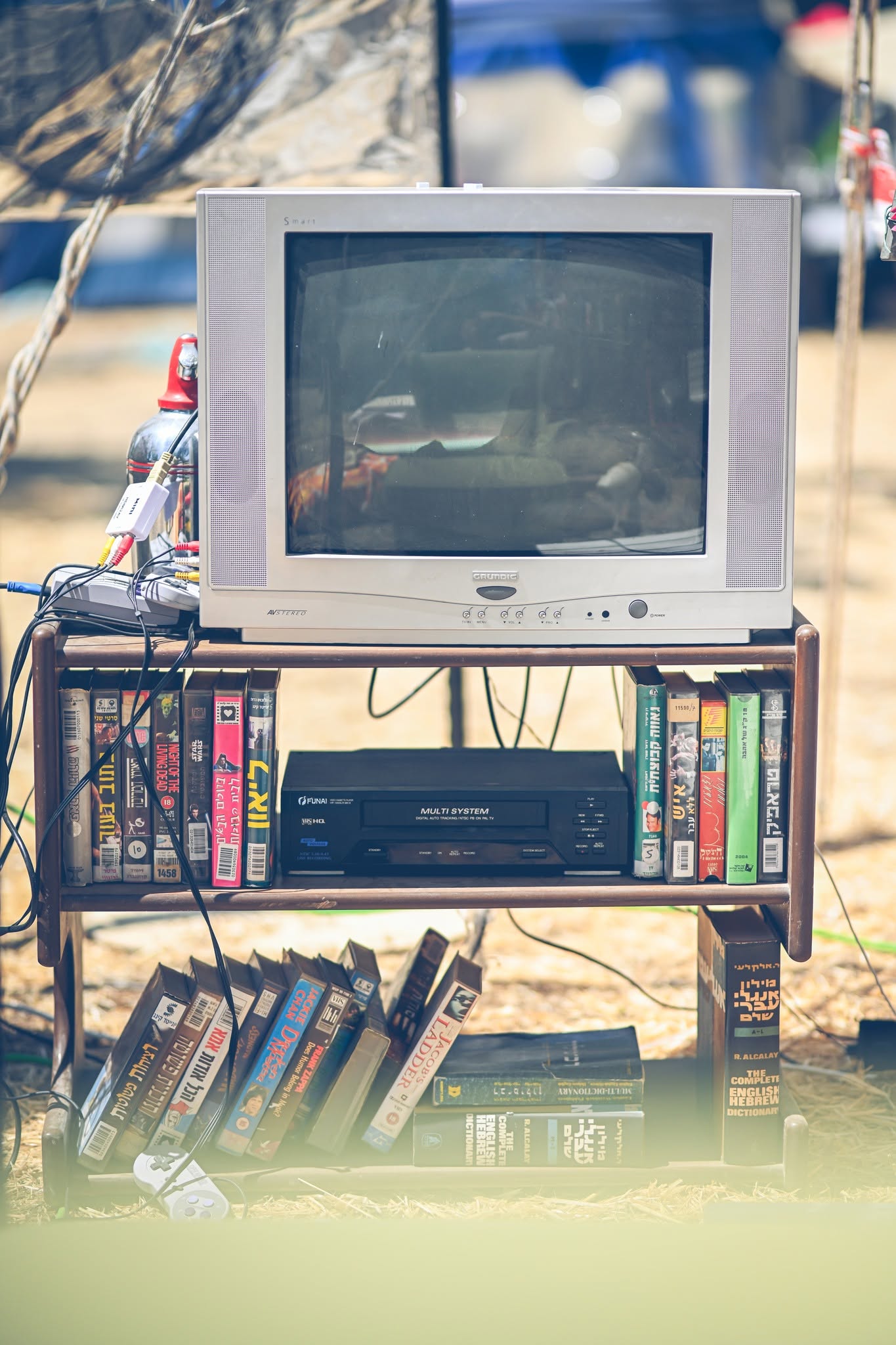 An old computer monitor and books on a makeshift stand.