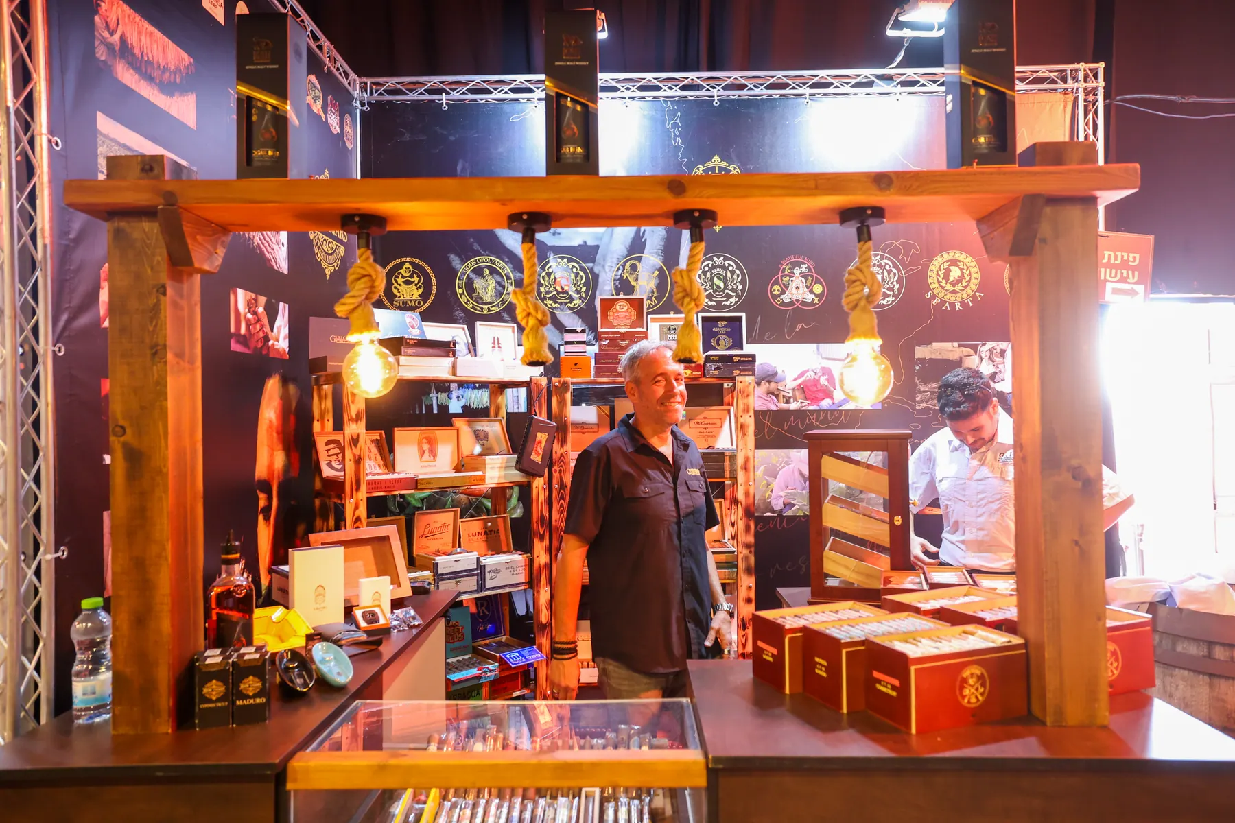 A designed display stand with shelves of bottles and accessories.